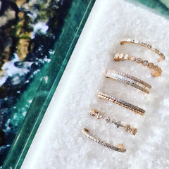 a selection of Liven's diamond bands including the bezel set diamond eternity band