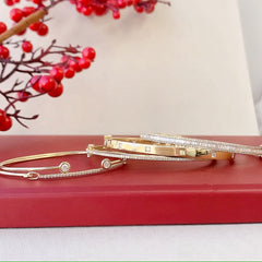 collection of classic bangles and cuffs with gold and diamonds