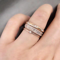 Heirloom baguette and round diamond halfway band worn as part of a stack with other Liven bands