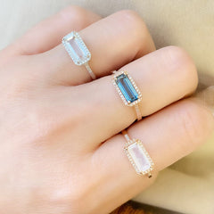 east-west emerald cut colored stone rings