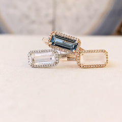 east-west emerald cut colored stone rings