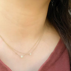 two different sizes of star necklace being worn