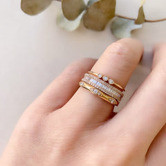 heirloom baguette diamond halfway band stacked with other liven rings