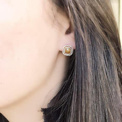 one of a kind rustic diamond earrings on ear