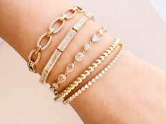 a rich selection of yellow gold bracelets with diamondas